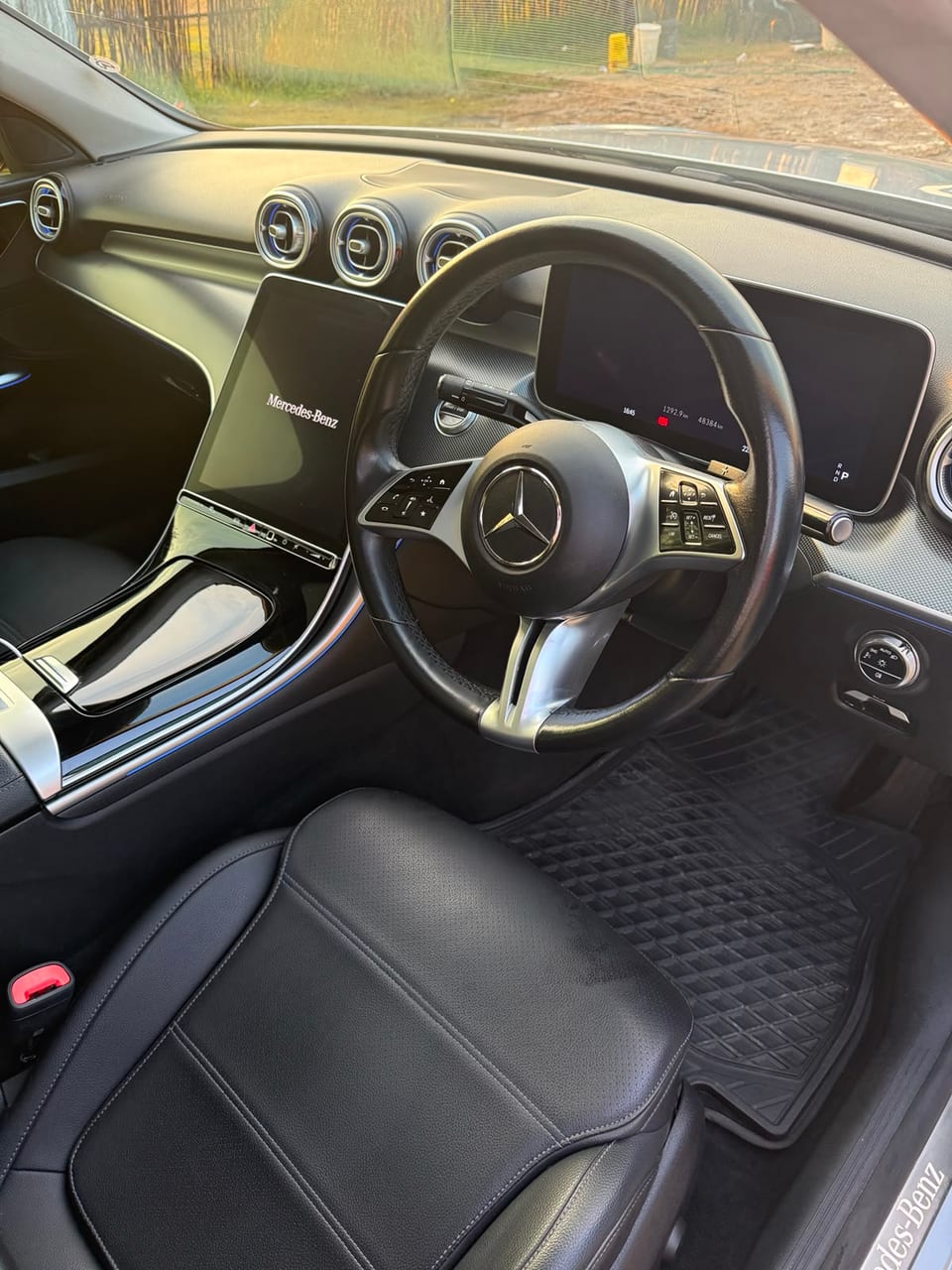 The cockpit — black leather seats, twin digital screens and an ambient trim strip